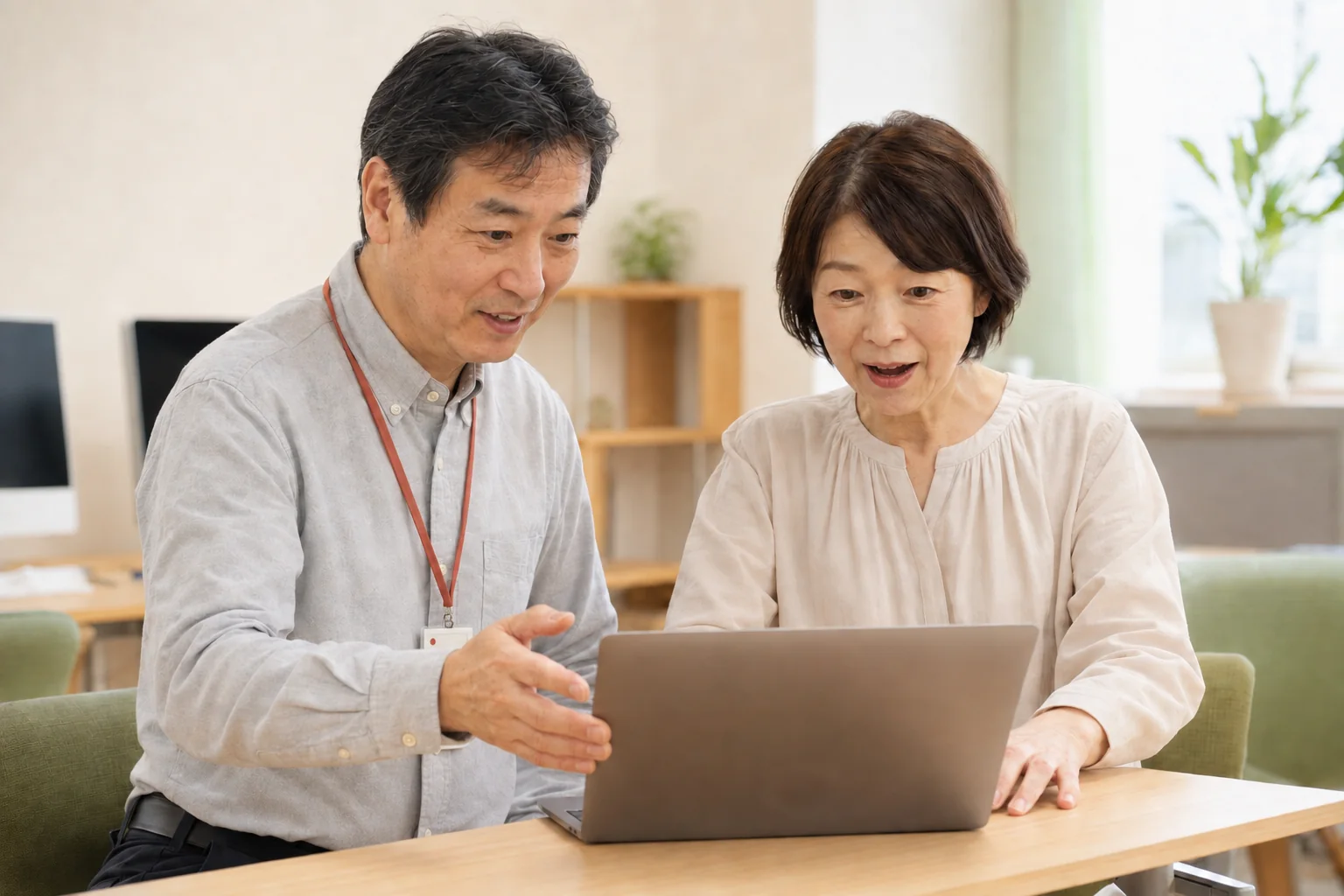 講師と生徒がパソコン画面を見て笑顔になっている様子